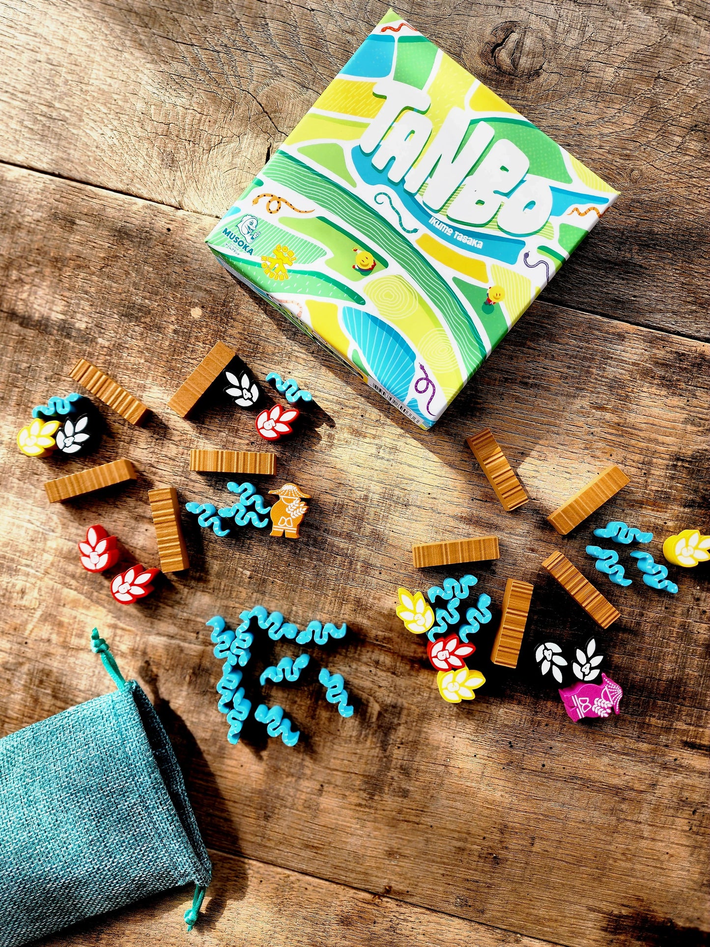 Tanbo game in progress with mancala-style sowing of rice