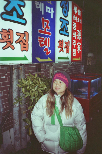 Musoka purple and pink beanie worn by a model