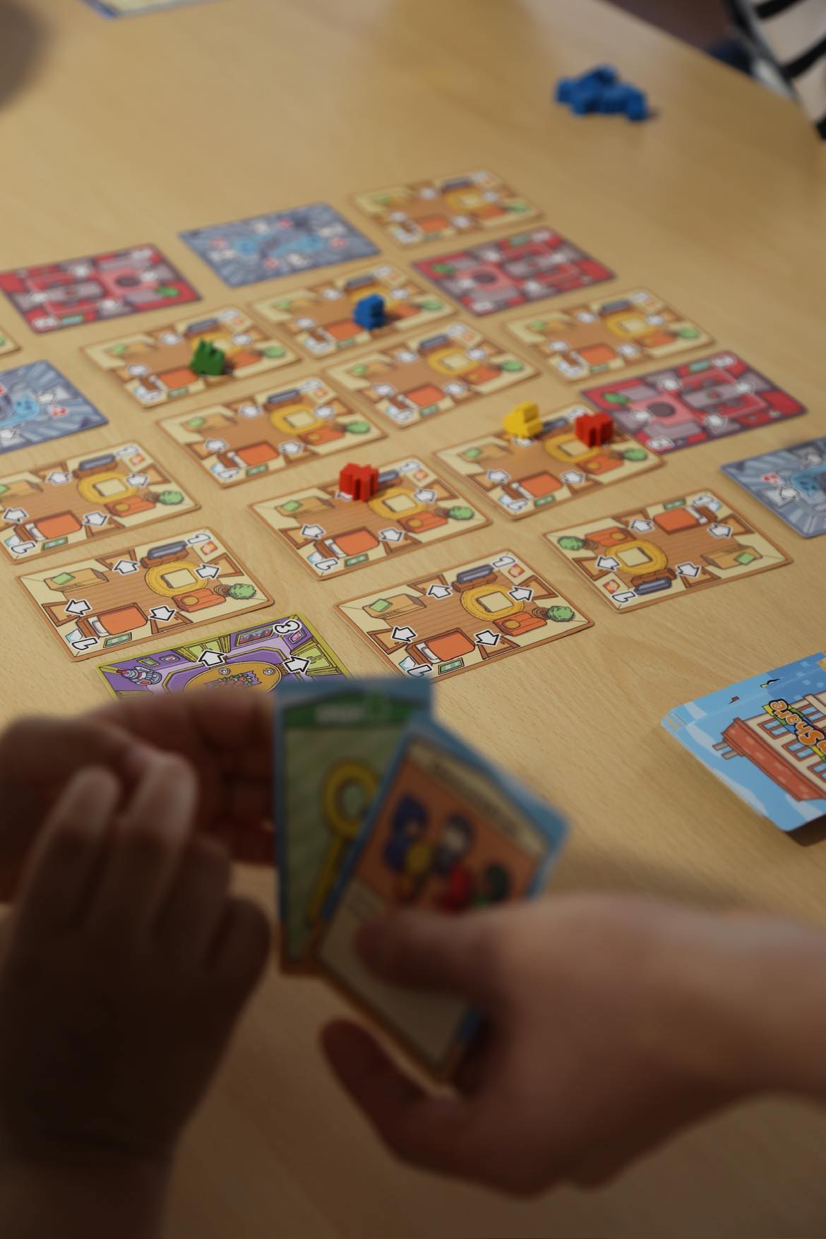 Room Share being played by a group around a table