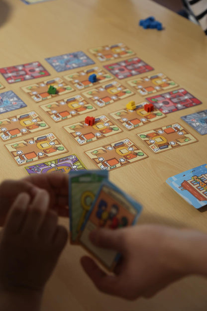 Room Share being played by a group around a table